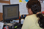 Woman at computer participating in the @YourSide Colleague® Cancer Care course