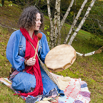 Métis woman drumming