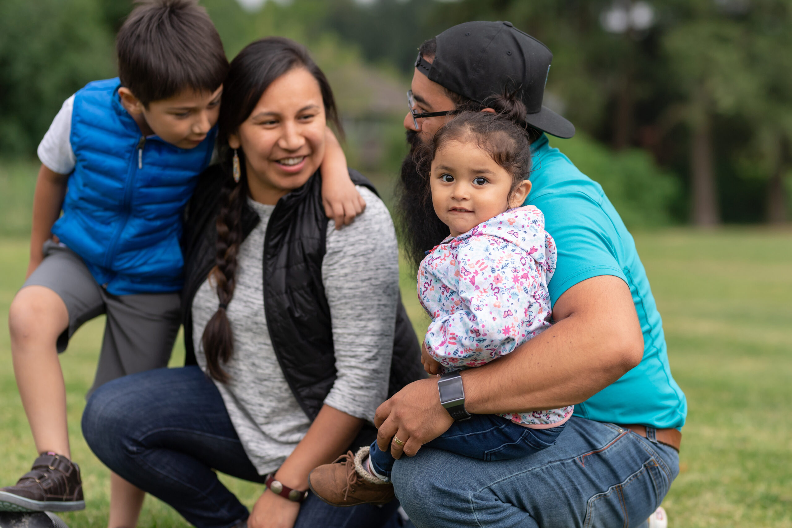 Native American family playing together on a soccer field